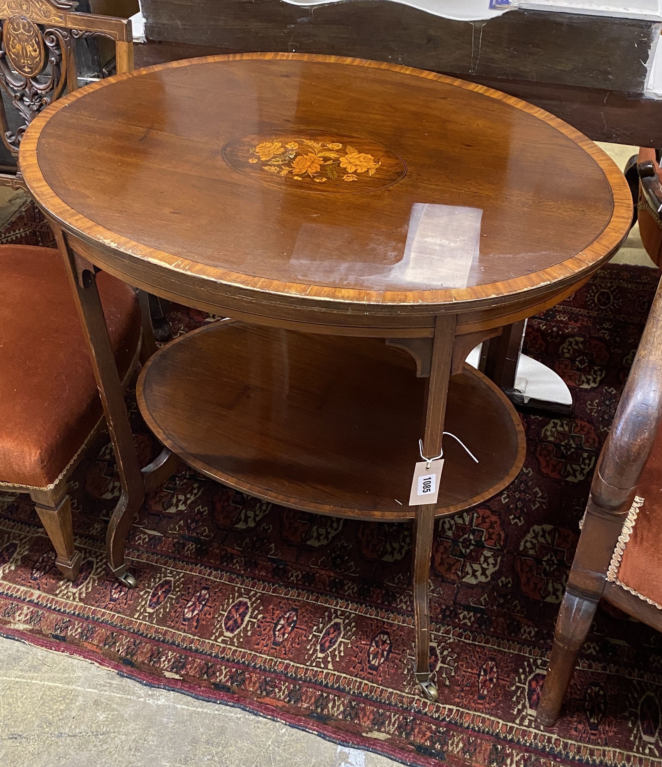 An Edwardian oval marquetry inlaid mahogany two tier occasional table, width 76cm, depth 54cm, height 69cm
